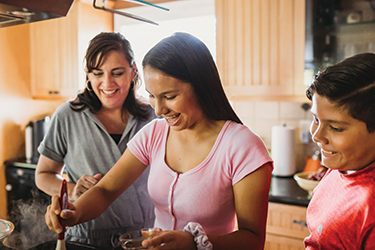 Minerva Quezada cooking with her children.